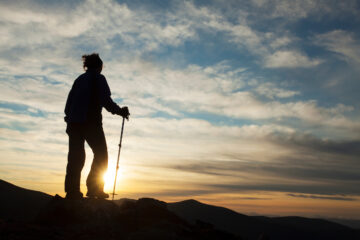 Walker silhouetted at sunset on Braeriach, Cairngorms National Park, Scotland